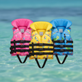 Colorful kids life jackets with ocean background